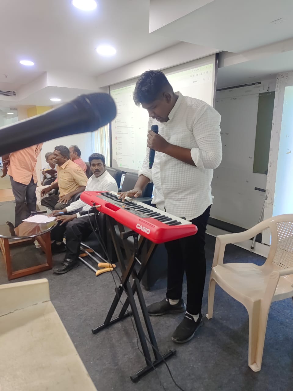 KRM Special School student singing and playing keyboard at an event