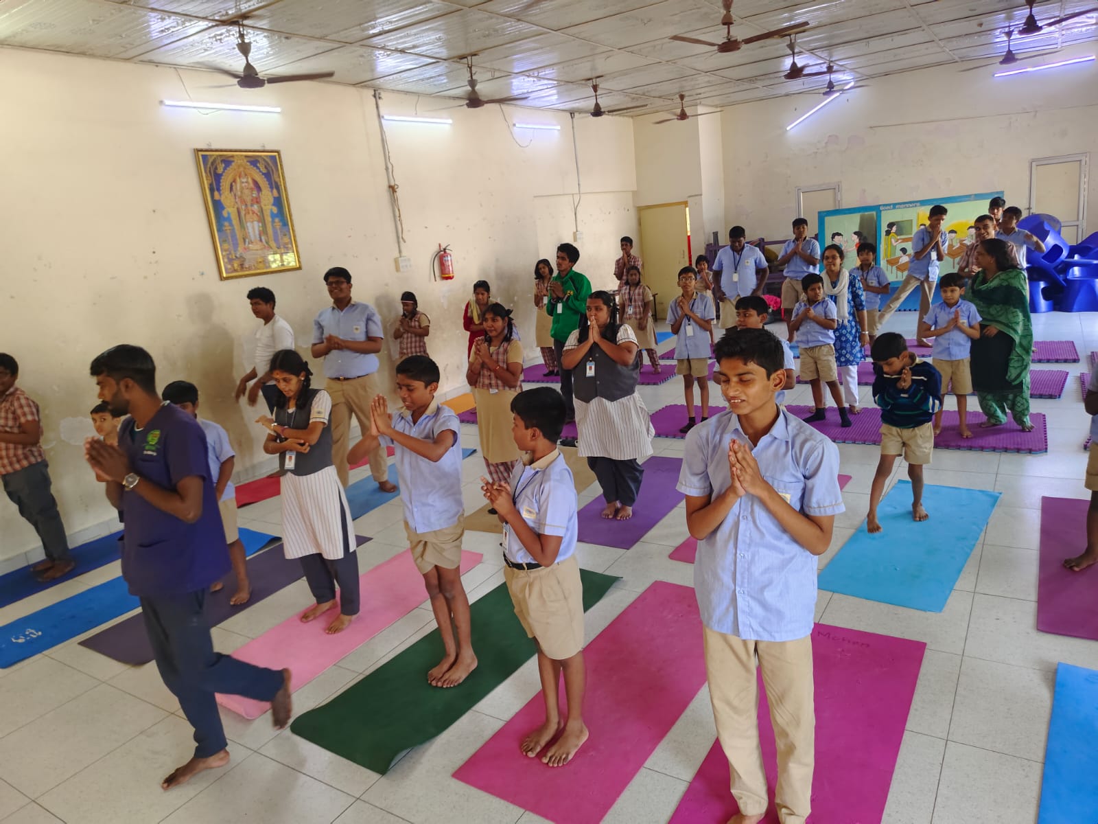KRM Special School students standing in prayer pose during a yoga session