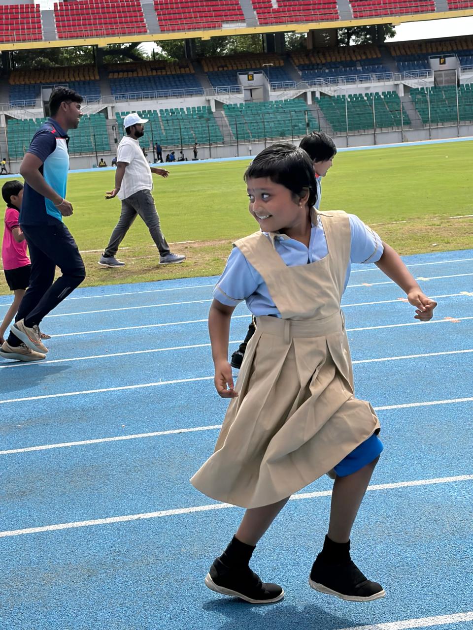 KRM Special School student running on the stadium track at a sports event